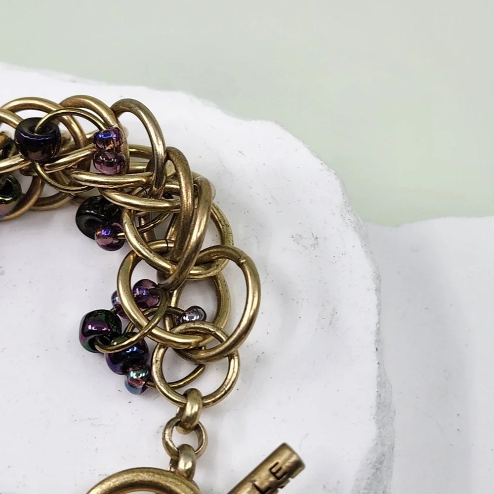 Kenneth Cole Gold Tone Woven Ring Bracelet Purple Bead Chunky Toggle Statement
